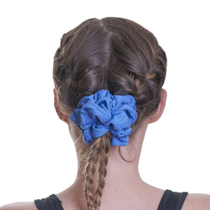 Back view of women wearing blue gym scrunchie in her braided hair