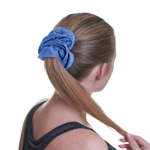 Back view of women wearing blue sports scrunchie used to hold up ponytail