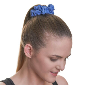 women wearing blue workout scrunchie looking to the ground
