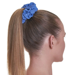 Side view of women wearing blue running sports scrunchie with hair in a ponytail