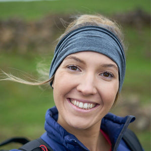 women wearing a striped/grey merino wool reversible ear warmer while hiking