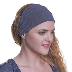 women wearing wide bamboo yoga headband with a grey/blue striped top