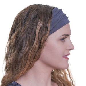 Side wiew of women wearing bamboo exercise headband with curly hair down.