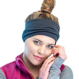 Head shot of women wearing a striped/grey merino wool reversible sports headband