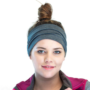 Head shot of women wearing a striped/grey merino wool reversible sports winter headband