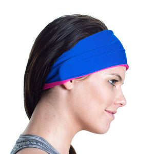 Women wearing a pink/blue reversible workout sweatband