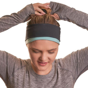 Women wearing reversible winter sports headband while pulling her hair up into a bun