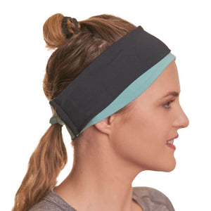 Side view of women wearing ponytail friendly reversible sports headband looking to the right