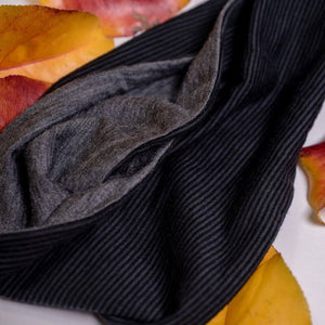 Close up of fabric used to make striped/grey merino wool reversible sports winter headband