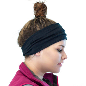 Side shot of women wearing a striped/grey merino wool reversible sports winter headband